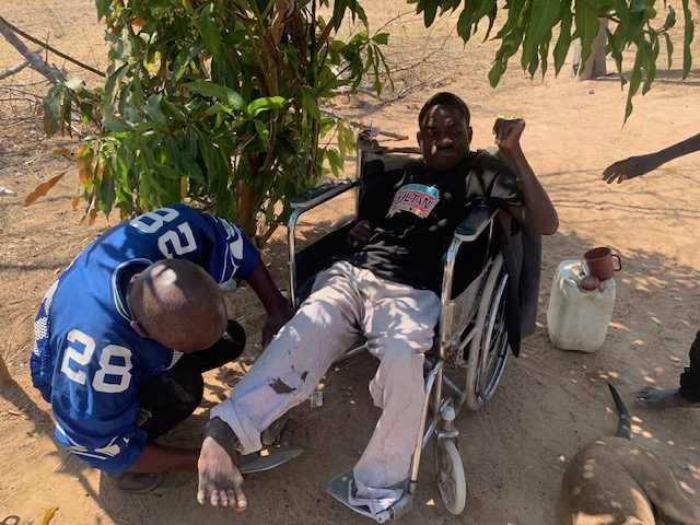 Kazolo with Robbie fixing wheelchair