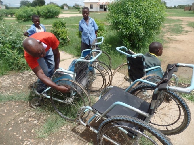 Choongo Robbie repairing wheelchair