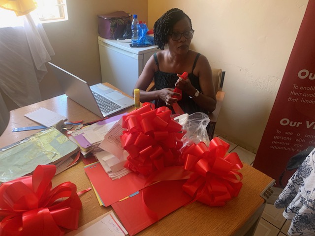 Brenda prepping table l decoartions for choongo hand over