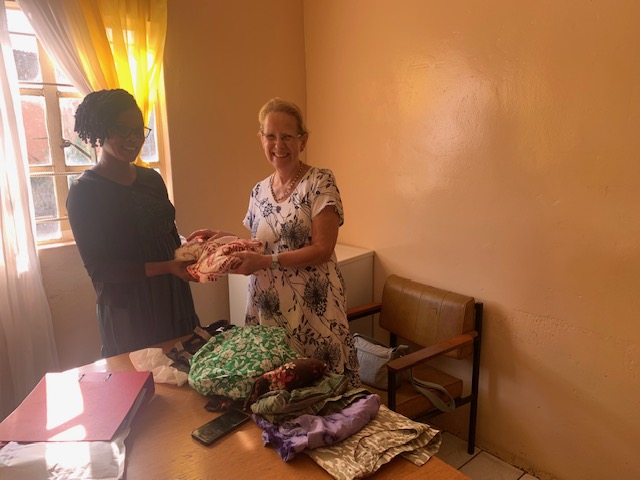 Clothing being handed over by Kath