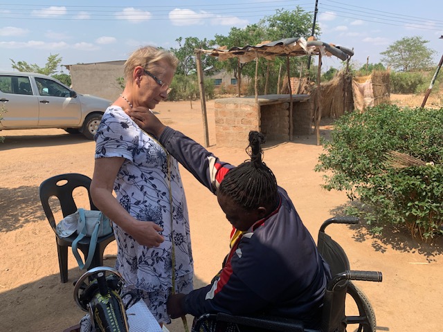 Kath being measured by seamstress Grace