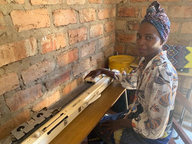 Naomi at her knitting machine funded by HHI