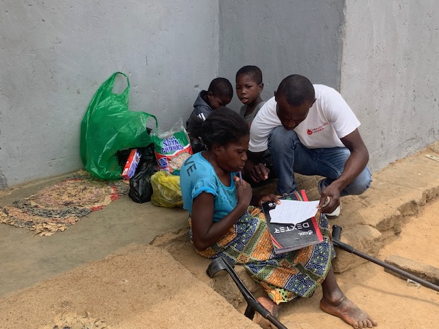 Priscilla signs for her monthly food support