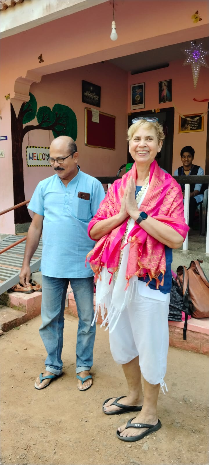 Jute being welcomed to Happy Valley with traditional shawl and__ jasmine garland