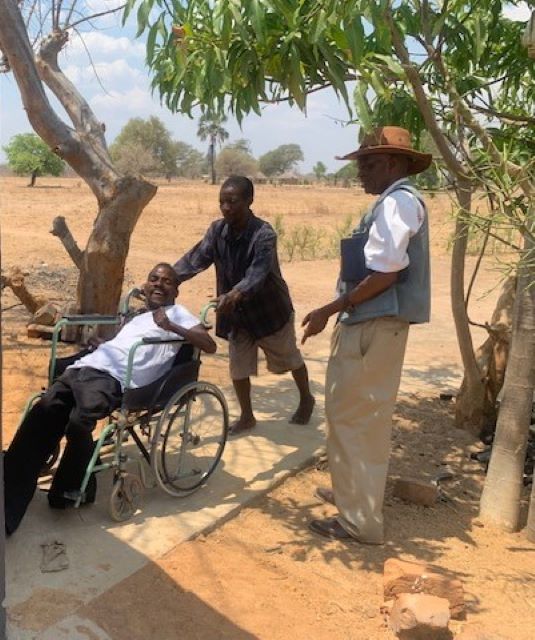 Kazolo's brother manages to take Kazolo to the new toilet with aid__ of ramps