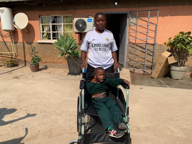 Swanna receiving wheelchair for the first time .