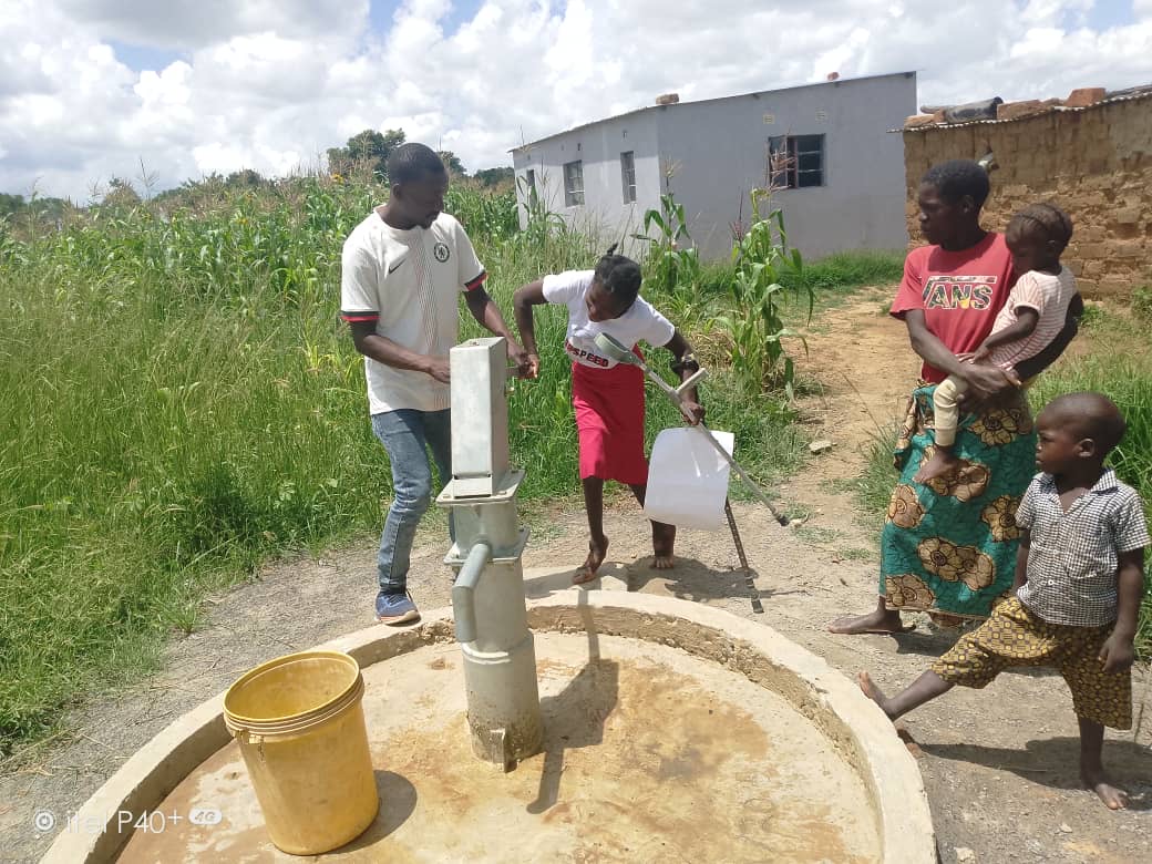 Disabled mother, Priscilla, accessing water from the new bore hole.__